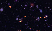 <span>Figure 1: A trove of galaxies, rich in carbon monoxide (indicating star-forming potential) were imaged by ALMA (orange) in the Hubble Ultra Deep Field.</span>