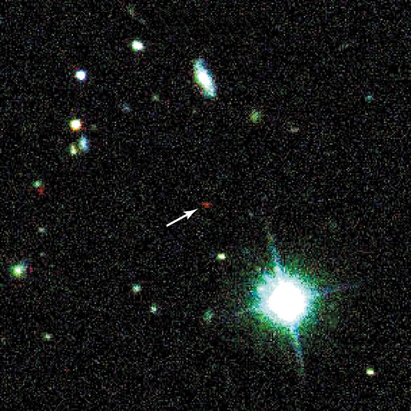 Abb. 1: Der entfernteste Quasar erscheint auf der Entdeckungsaufnahme als ein schwach leuchtendes, auffallend rotes Objekt (Pfeil) Abb. 1: Der entfernteste Quasar erscheint auf der Entdeckungsaufnahme als ein schwach leuchtendes, auffallend rotes Objekt (Pfeil)