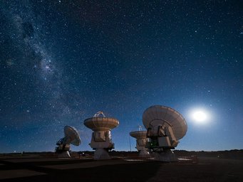 Four of the ALMA antennas gaze upon the night sky with the Milky Way to the left. Four of the ALMA antennas gaze upon the night sky with the Milky Way to the left.