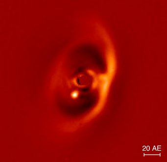 Nah-Infrarot-Aufnahme der PDS70-Scheibe aufgenommen mit dem SPHERE-Instrument. Der junge Exoplanet PDS 70 b ist deutlich als helles Signal am inneren Rand der Lücke (dunkler Bereich) zu erkennen. Die vom Zentralstern ausgehende Emission wurde ausgeblendet. Der Balken rechts unten zeigt den linearen Maßstab des Bildes in einer Entfernung von 370 Lichtjahren an. Nah-Infrarot-Aufnahme der PDS70-Scheibe aufgenommen mit dem SPHERE-Instrument. Der junge Exoplanet PDS 70 b ist deutlich als helles Signal am inneren Rand der Lücke (dunkler Bereich) zu erkennen. Die vom Zentralstern ausgehende Emission wurde ausgeblendet. Der Balken rechts unten zeigt den linearen Maßstab des Bildes in einer Entfernung von 370 Lichtjahren an.