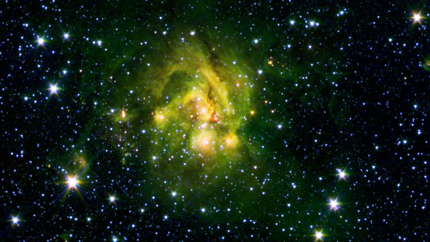 This image shows an outflow of gas (red blob in the centre) from a new star as it jets from a space object dubbed IRAS 21078+5211. The picture is a combination of data from the Spitzer Space Telescope and the Two Micron All Sky Survey (2MASS). A large coloured, nebulous cloud in the middle of a black background with many dots (stars) of different brightness.