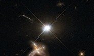 Figure 1: Artist's impression of a quasar and neighboring merging galaxy. The galaxies observed by Decarli and collaborators are so distant that no detailed images are possible at present. This combination of images of nearby counterparts gives an impression of how they might look in more detail.