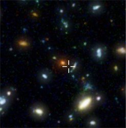 Abbildung 1: In diesem Ausschnitt aus dem Hubble Deep Field befindet sich HDF850.1. Das Kreuz zeigt den Ort der Submillimeter-Galaxie an – im herkömmlichen, sichtbaren Licht ist die Galaxie unsichtbar. Abbildung 1: In diesem Ausschnitt aus dem Hubble Deep Field befindet sich HDF850.1. Das Kreuz zeigt den Ort der Submillimeter-Galaxie an – im herkömmlichen, sichtbaren Licht ist die Galaxie unsichtbar.