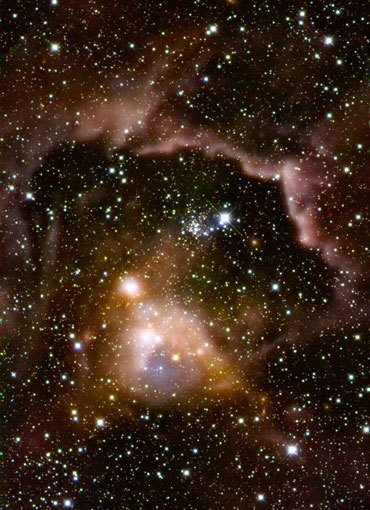 Abb. 1: Aufnahme der Sternentstehungsregion ISOSS J22164+6003 im Infrarotlicht: Massereiche Sterne in frühen Phasen ihrer Entwicklung. Einige der Protosterne sind noch tief in bis zu -255 Grad Celsius kaltes Gas und Staub eingebettet und nur im fernen Infrarot nachweisbar. Kombination von HERSCHEL-Beobachtungen im fernen Infrarot (rötliche und gelbliche Strukturen) mit einem Bild im nahen Infrarot (Calar-Alto-Observatorium). Abb. 1: Aufnahme der Sternentstehungsregion ISOSS J22164+6003 im Infrarotlicht: Massereiche Sterne in frühen Phasen ihrer Entwicklung. Einige der Protosterne sind noch tief in bis zu -255 Grad Celsius kaltes Gas und Staub eingebettet und nur im fernen Infrarot nachweisbar. Kombination von HERSCHEL-Beobachtungen im fernen Infrarot (rötliche und gelbliche Strukturen) mit einem Bild im nahen Infrarot (Calar-Alto-Observatorium).