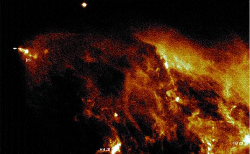 Fig. 4: A newborn star (cross), deeply embedded within the dust of the molecular cloud L 1551 from which it formed. The star is not visible in the optical but only in infrared light. It emits a bright jet of ionized gas, illuminates the extended reflection nebula and lights the structures denoted HH-28 and HH-29. Fig. 4: A newborn star (cross), deeply embedded within the dust of the molecular cloud L 1551 from which it formed. The star is not visible in the optical but only in infrared light. It emits a bright jet of ionized gas, illuminates the extended reflection nebula and lights the structures denoted HH-28 and HH-29.