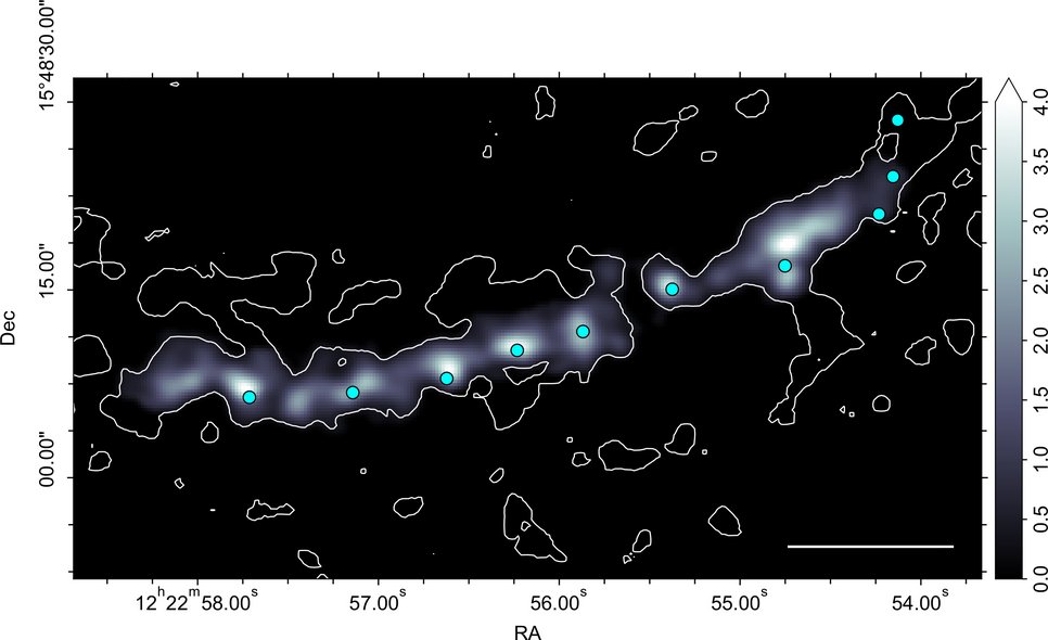 Image of the molecular gas (carbon monoxide) distribution in the southern spiral arm of the galaxy NGC 4321 spanning roughly 15,000 light years across. The bright spots indicate giant molecular clouds that are semi-regularly spaced inside the ridge of more dilute gas inside the spiral arm. The cyan circles depict the locations of star forming complexes.