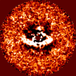 Figure 1: This image taken with the HiCIAO planet-hunter camera on SUBARU Telescope shows a bright arc of scattered light (white) from the protoplanetary disk around the young star LkCa 15 (center, masked out with a dark circle). The arc’s sharp inner edge traces the outline of a wide gap in the disk. The gap is decidedly lopsided – it is markedly wider on the left side – and has most likely been carved out of the disk by one or more newborn planets that orbit the star.