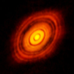This image, taken with the ALMA Observatory in 2014, was the first to reveal a ring-like structure in a protoplanetary disk - in this case, the disk around the young star HL Tauri. The visible disk has a radius of a bit over 100 astronomical units, that is, over 100 times the average Earth-Sun distance. For comparison: In our solar system, the maximal distance of Pluto from the Sun amounts to about 50 astronomical units. The research described here shows the key role ring-like structures like this are likely to have played in the genesis of our Solar System.