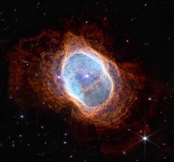Fiery finale: having reached the end of its life, a star blows its gaseous atmosphere into space, creating this Southern Ring Nebula. A luminous turquoise oval structure surrounded by an orange, flaky envelope against a black background. In the centre a bright luminous dot.