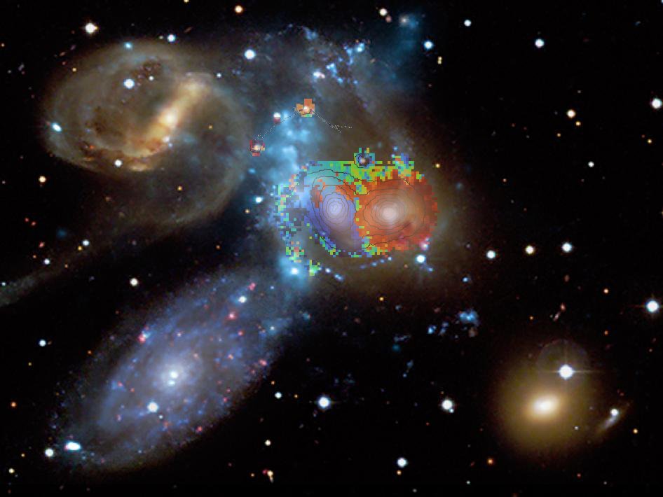 Image of the galaxies of "Stephan's Quintet"; overlaid over two of the galaxies is color-coded information about the velocity with which the region in question moves towards us or away from us. That data was obtained with WEAVE.