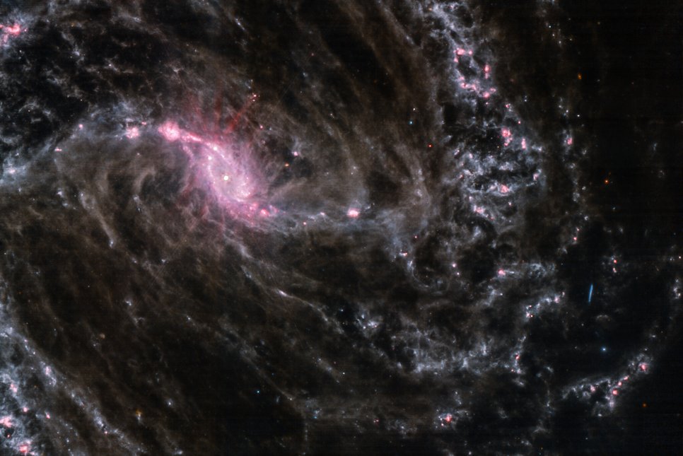 NGC 1365 is a highly active barred spiral galaxy at a distance of 64 million light-years. Gas and dust along the bar link the spiral arms to the galactic centre. The bar constantly funnels new gas towards the galaxy’s core and fuels the currently ongoing star formation there. The image is composed in the same way as described for NGC 628.