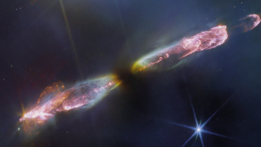Featured in this image from the James Webb Space Telescope is Herbig-Haro 211 (HH 211), a bipolar jet travelling through interstellar space at supersonic speeds. At roughly 1,000 light-years away from Earth in the constellation Perseus, the object is one of the youngest and nearest protostellar outflows, making it an ideal target for JWST. Featured in this image from the James Webb Space Telescope is Herbig-Haro 211 (HH 211), a bipolar jet travelling through interstellar space at supersonic speeds. At roughly 1,000 light-years away from Earth in the constellation Perseus, the object is one of the youngest and nearest protostellar outflows, making it an ideal target for JWST.