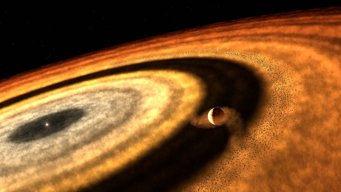 Artistic rendering of a young planetary system seen from within the protoplanetary disc. In the foreground, a planet orbits within a vast, flattened disc of gas and dust, shown in swirling shades of orange, yellow, and white. The planet appears to be carving a dark, circular gap into the disc. A smaller bright star shines at the centre, surrounded by concentric rings. Pebble-sized particles are visible near the planet's orbit, giving a sense of depth and motion.